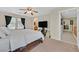 Bedroom showcasing a large bed, ensuite bathroom, and modern ceiling fan at 9009 Ochoa St, Las Vegas, NV 89143