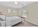 Neutral bedroom with carpet flooring, a window, and a cozy bed at 9009 Ochoa St, Las Vegas, NV 89143