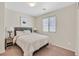 Cozy bedroom featuring neutral walls, carpet, and a decorative headboard with lamps at 9009 Ochoa St, Las Vegas, NV 89143