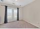 A cozy bedroom with curtains on glass doors leading to the balcony at 9009 Ochoa St, Las Vegas, NV 89143