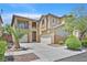 Inviting two-story home featuring a three-car garage and a well-manicured front yard at 9009 Ochoa St, Las Vegas, NV 89143