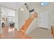 Bright foyer featuring hardwood floors, a staircase with wood banister, and a tiled entrance at 9009 Ochoa St, Las Vegas, NV 89143