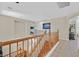 Hallway with hardwood flooring, light-colored walls, and a staircase leading upstairs at 9009 Ochoa St, Las Vegas, NV 89143