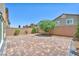 Paver patio in backyard with privacy fence and desert landscaping at 9198 Rolling Sky Dr, Las Vegas, NV 89178