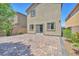 Paver patio in backyard with privacy fence and sliding glass door access to the house at 9198 Rolling Sky Dr, Las Vegas, NV 89178