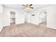 Large carpeted bedroom with an open layout, ceiling fan, and access to a walk-in closet and en-suite bathroom at 9198 Rolling Sky Dr, Las Vegas, NV 89178