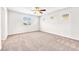 A large bedroom with multiple windows, neutral carpet and walls, providing lots of natural light at 9198 Rolling Sky Dr, Las Vegas, NV 89178
