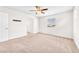A comfortable bedroom with ceiling fan, window, and neutral walls and carpet at 9198 Rolling Sky Dr, Las Vegas, NV 89178