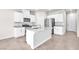 Modern kitchen featuring white cabinets, stainless steel appliances, and an island with a sink at 9198 Rolling Sky Dr, Las Vegas, NV 89178