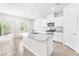 Open kitchen with stainless steel appliances, an island with a sink, and a sliding glass door to the outdoor space at 9198 Rolling Sky Dr, Las Vegas, NV 89178