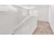 Bright stairwell featuring white walls and neutral carpet leading to the upper level of the home at 9198 Rolling Sky Dr, Las Vegas, NV 89178