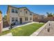 A well-kept backyard with green turf, a BBQ, and privacy wall for outdoor gatherings and relaxation at 9413 Steeltree St, Las Vegas, NV 89143