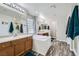 Bright bathroom featuring a soaking tub, dual sinks, and modern wood-look flooring at 9413 Steeltree St, Las Vegas, NV 89143