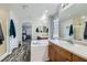 Bright bathroom with double sink vanity, soaking tub and wood-look floors at 9413 Steeltree St, Las Vegas, NV 89143