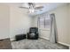 Neutral bedroom with a comfortable chair, soft carpet, and natural light at 9413 Steeltree St, Las Vegas, NV 89143