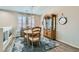 Cozy dining nook featuring a round table with seating for four, a rug, and a display cabinet at 9413 Steeltree St, Las Vegas, NV 89143