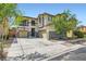 Charming two-story home with a two-car garage, a balcony, and an expansive driveway and front yard at 9413 Steeltree St, Las Vegas, NV 89143
