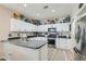 Bright kitchen features white cabinets, a gray countertop, and modern stainless steel appliances at 9413 Steeltree St, Las Vegas, NV 89143