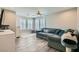 Spacious living room with a large sectional sofa, ceiling fan, and ample natural light at 9413 Steeltree St, Las Vegas, NV 89143