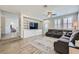 Spacious living room with modern ceiling fan, recessed lights, and built-in shelving around TV at 9413 Steeltree St, Las Vegas, NV 89143