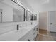 This bathroom has a dual sink vanity with quartz countertops and modern fixtures at 9437 January Dr, Las Vegas, NV 89134