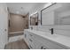 This modern bathroom has a double vanity, square mirrors, and a tile shower at 9437 January Dr, Las Vegas, NV 89134