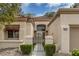 Charming front entrance with a tiled roof, an arched window and courtyard gate at 9437 January Dr, Las Vegas, NV 89134