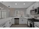 Bright modern kitchen features white cabinets, quartz countertops, stainless steel appliances, and stylish backsplash at 9437 January Dr, Las Vegas, NV 89134