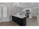 Modern kitchen features white cabinets, stainless steel appliances, quartz countertops, and eat in breakfast bar at 9437 January Dr, Las Vegas, NV 89134