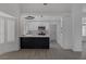 Open concept kitchen with white cabinets, quartz countertops, stainless steel appliances and eat in breakfast bar at 9437 January Dr, Las Vegas, NV 89134