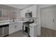 Modern kitchen features stainless steel appliances, white cabinets, stylish backsplash and quartz countertops at 9437 January Dr, Las Vegas, NV 89134