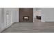 Modern living room featuring a cozy fireplace with an open concept view of kitchen at 9437 January Dr, Las Vegas, NV 89134