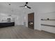 Bright living room featuring a fireplace, open floor plan, light wood floors, and a modern kitchen at 9437 January Dr, Las Vegas, NV 89134