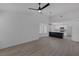 Open living space with bay window, light wood floors, ceiling fan, and view to a modern kitchen at 9437 January Dr, Las Vegas, NV 89134