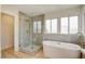 Modern bathroom with stand alone shower, stand alone tub and bright lighting at 955 Leadville Meadows Dr, Henderson, NV 89052