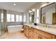 Bright bathroom with double sinks, stand alone shower and modern tub at 955 Leadville Meadows Dr, Henderson, NV 89052