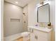 Modern bathroom with sleek vanity, gold fixtures, walk-in shower, and contemporary design at 955 Leadville Meadows Dr, Henderson, NV 89052