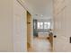 Hallway view to a spacious bathroom with modern tub, stand alone shower, and hardwood floors at 955 Leadville Meadows Dr, Henderson, NV 89052