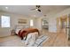 Comfortable bedroom featuring a modern bed frame, wood flooring and sitting area at 955 Leadville Meadows Dr, Henderson, NV 89052