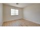Empty bedroom with wood floors, white walls, and natural light at 955 Leadville Meadows Dr, Henderson, NV 89052