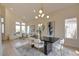 Bright dining area featuring a modern chandelier, stylish chairs, and an open layout with plenty of natural light at 955 Leadville Meadows Dr, Henderson, NV 89052