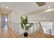 Second floor hallway with wood floors, white doors, and a view of the living room at 955 Leadville Meadows Dr, Henderson, NV 89052