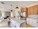 Bright kitchen features a center island with seating, stainless steel appliances, and connects to the living area at 955 Leadville Meadows Dr, Henderson, NV 89052