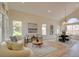 Spacious living room featuring stylish furniture, contemporary art, and a dining area with modern lighting at 955 Leadville Meadows Dr, Henderson, NV 89052