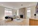 Inviting living room featuring a fireplace, hardwood floors, and an abundance of natural light from many windows at 955 Leadville Meadows Dr, Henderson, NV 89052