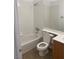 Bathroom featuring a shower-tub combination with white tile surround, a toilet, and a vanity with sink at 9839 Brook Canyon Dr, Las Vegas, NV 89147