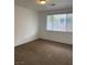 Bright bedroom featuring neutral walls, carpeted floors, and a window with blinds for natural light at 9839 Brook Canyon Dr, Las Vegas, NV 89147