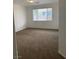 Large bedroom featuring neutral walls, carpeted floors, and a window with blinds for natural light at 9839 Brook Canyon Dr, Las Vegas, NV 89147