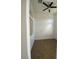 Clean bedroom showcasing a ceiling fan, tiled flooring, and bright neutral walls at 9839 Brook Canyon Dr, Las Vegas, NV 89147