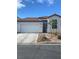 Charming single-story home with a two-car garage and a well-maintained front yard at 9839 Brook Canyon Dr, Las Vegas, NV 89147